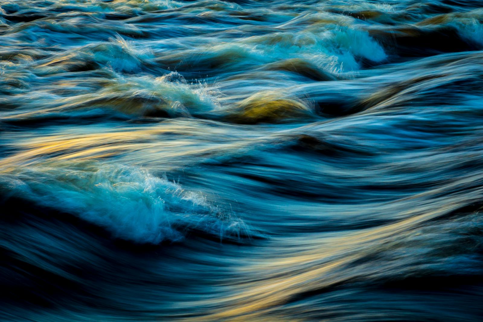 Capture of flowing ocean waves in motion, showcasing the vibrant colors and dynamic movement of water.